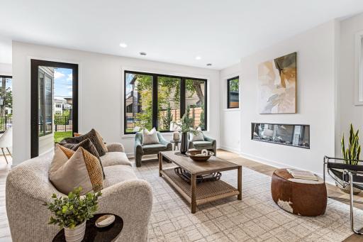 Nicely sized living room boasts walls of windows, a linear fireplace, and flows out to the patio and backyard.