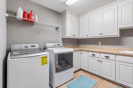 Upper level laundry with lots of cupboard space.