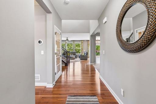 View as you enter the home, family room straight ahead, and the dining and kitchen to your right.