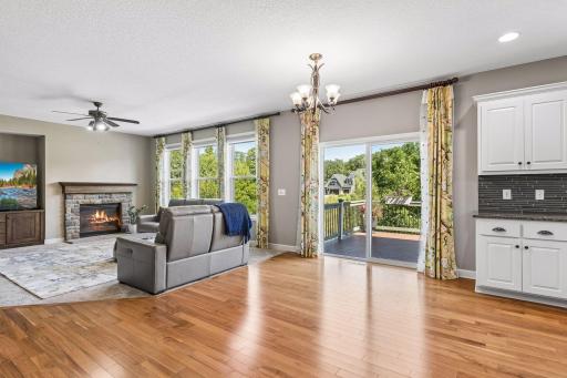 Family room with gas burning fireplace and large windows, nook for TV.