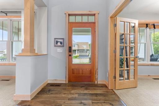 The large foyer opens to the dining room and office. Notice the lovely French doors and raised panel front door with upper transom window. 1137 Pioneer Trail, Bayport, MN