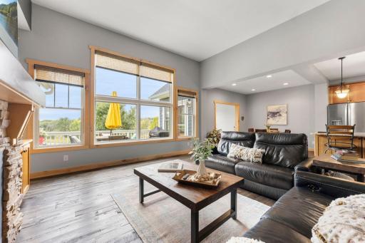 The large windows overlook the deck with nature views beyond. 1137 Pioneer Trail, Bayport, MN