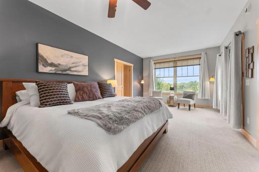 The main level Primary Bedroom Suite has a sitting area with lovely views and walk out to the deck. 1137 Pioneer Trail, Bayport, MN