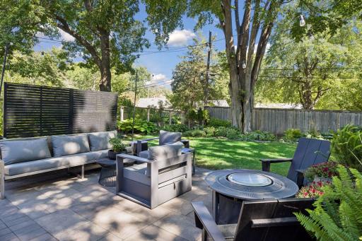 The entire back yard is fenced and landscaped, and the limestone border shapes your enchanting perennial garden filled with hosta and other low maintenance plantings