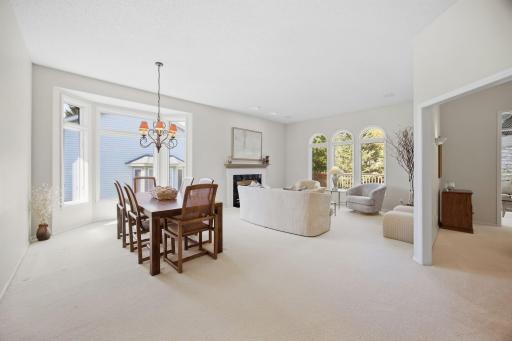 Formal dining room has bayed window with transoms adding more west light.