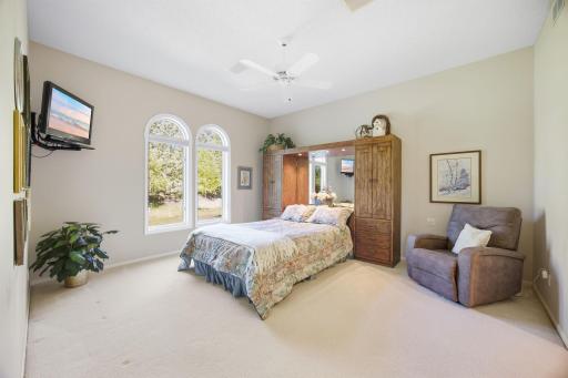 Primary bedroom with windows with roundtops.