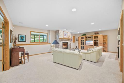 Lower level family room has brick gas fireplace with a raised hearth.