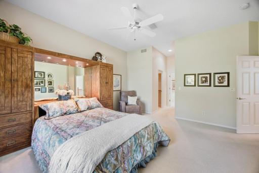 Primary bedroom leads to ensuite bath and his and her closets.