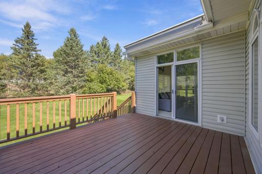 Deck off sunroom has stairs down to the yard from the deck.