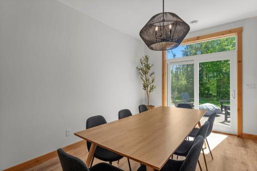 Adjoining dining area stays bright and open, connected to both the kitchen and living room, with direct patio access making it easy to take meals and gatherings outside.