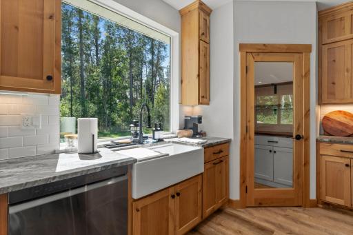 Walk-in pantry with built-in cabinetry and shelving for organized storage.