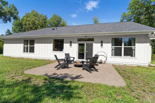 Spacious backyard patio surrounded by wooded privacy, creating a peaceful outdoor retreat.