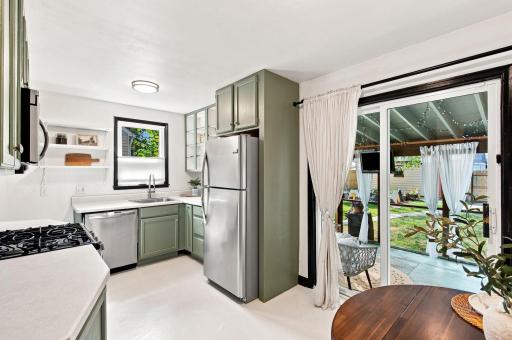 Charming eat-in kitchen with sage green painted cabinets