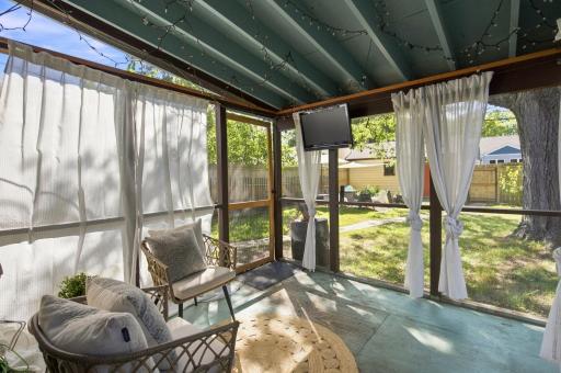 Main floor screened-in porch just beyond the kitchen; tv and lights can stay!