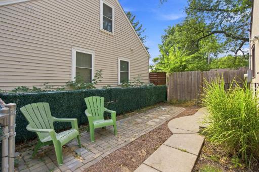 Charming paver side patio beyond the kitchen perfect for a grilling set up