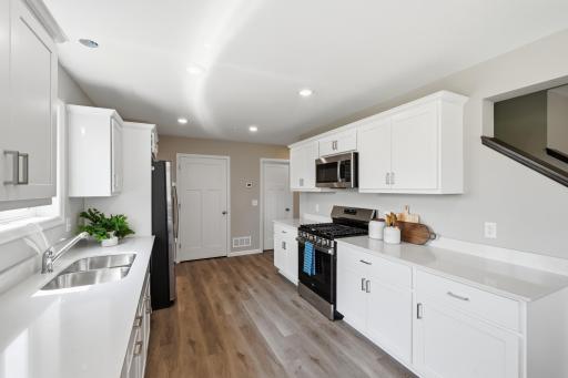 Painted cabinetry, crown molding, hardware, and stainless steel appliances create a clean, polished look. *photos of previously staged home, same floor plan and finishes however some features are not exact*