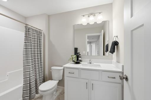 A full secondary bathroom conveniently serves the additional bedrooms and loft. *photos of previously staged home, same floor plan and finishes however some features are not exact*