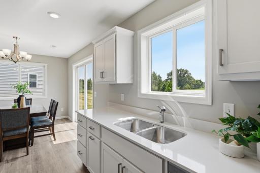 Thoughtful storage, generous counter space, and a built-in trash pullout make this kitchen as functional as it is beautiful. *photos of previously staged home, same floor plan and finishes however some features are not exact*