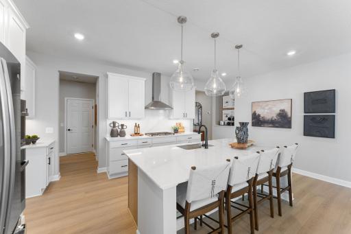 The flowing layout of this kitchen allows residents to easily access the extensive cabinetry space and a nearby butlerâs pantry