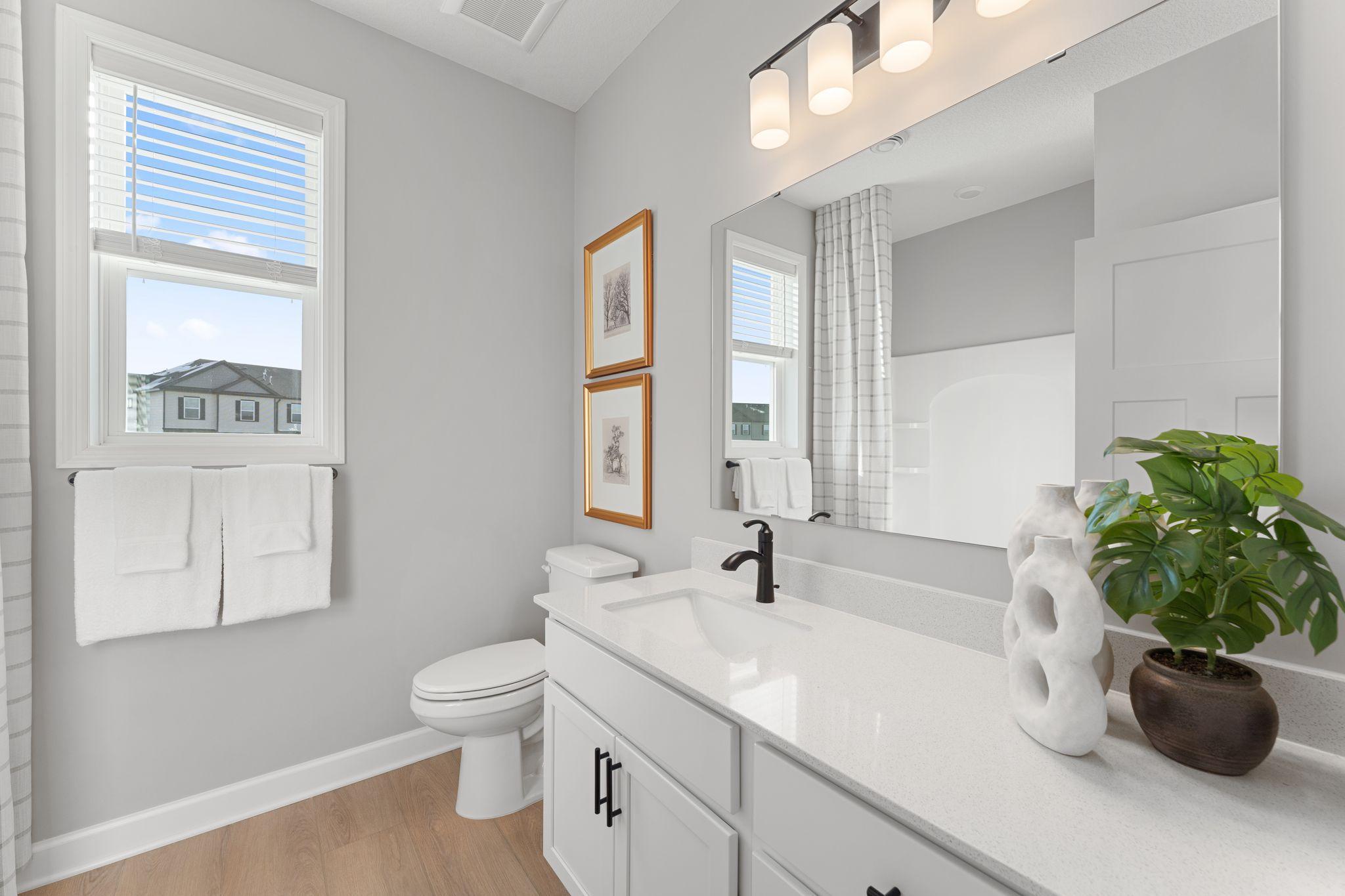This full-sized bathroom is arranged near the secondary bedrooms in a well-thought-out design to promote balanced living.