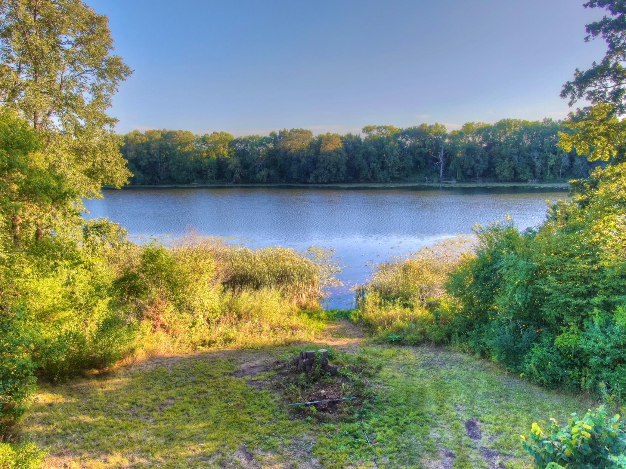 View of the area that the seller has started to clear for a path down to the lake. This property is surrounded by wildlife from deer to a variety of birds. In years past there was an eagle's nest across the bay from this property.