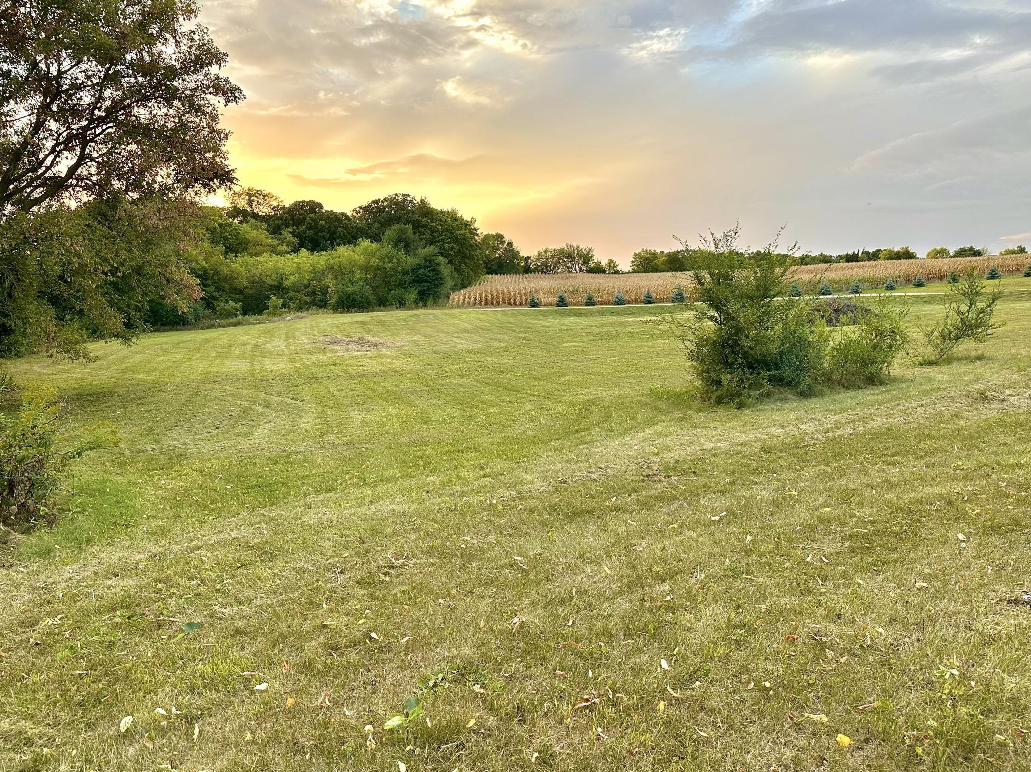 The slow sloping lot is very usable with mature trees offering privacy to the South and farm fields to the North and West.