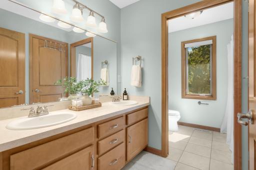 Full bathroom on the upper level has dual sinks
