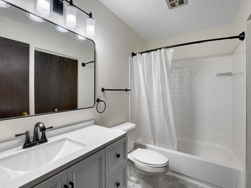 The gorgeous bathroom is also all new: floor, vanity, mirror, lighting, fixtures and bath surround. There's also a full walk-in closet not shown in the photo.