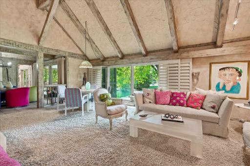 Large windows overlook the backyard & pond