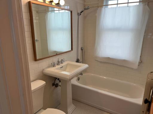 Main level full bath. Ceramic shower and tub surround and flooring. Pedestal sink. Nice big soaking tub.