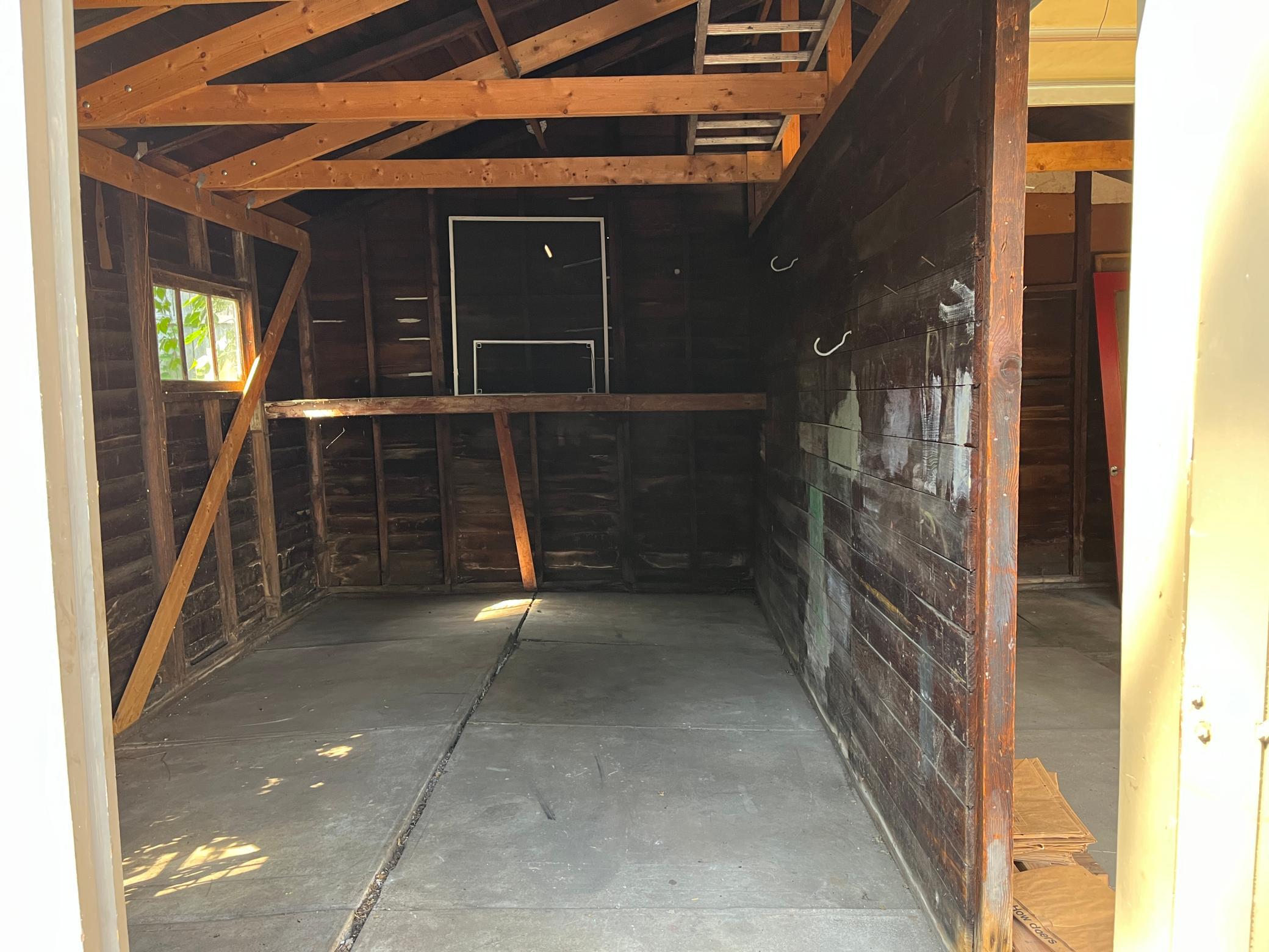 Double garage. This is the side with the "barn doors." The opening is 8' wide x 6' 11" tall. That's a storage shelf in the deep end.