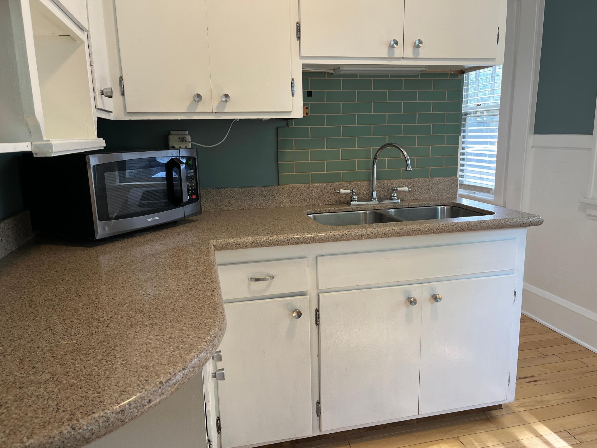 Granite counters and a stainless double sink. Maple flooring.