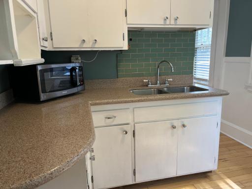 Granite counters and a stainless double sink. Maple flooring.