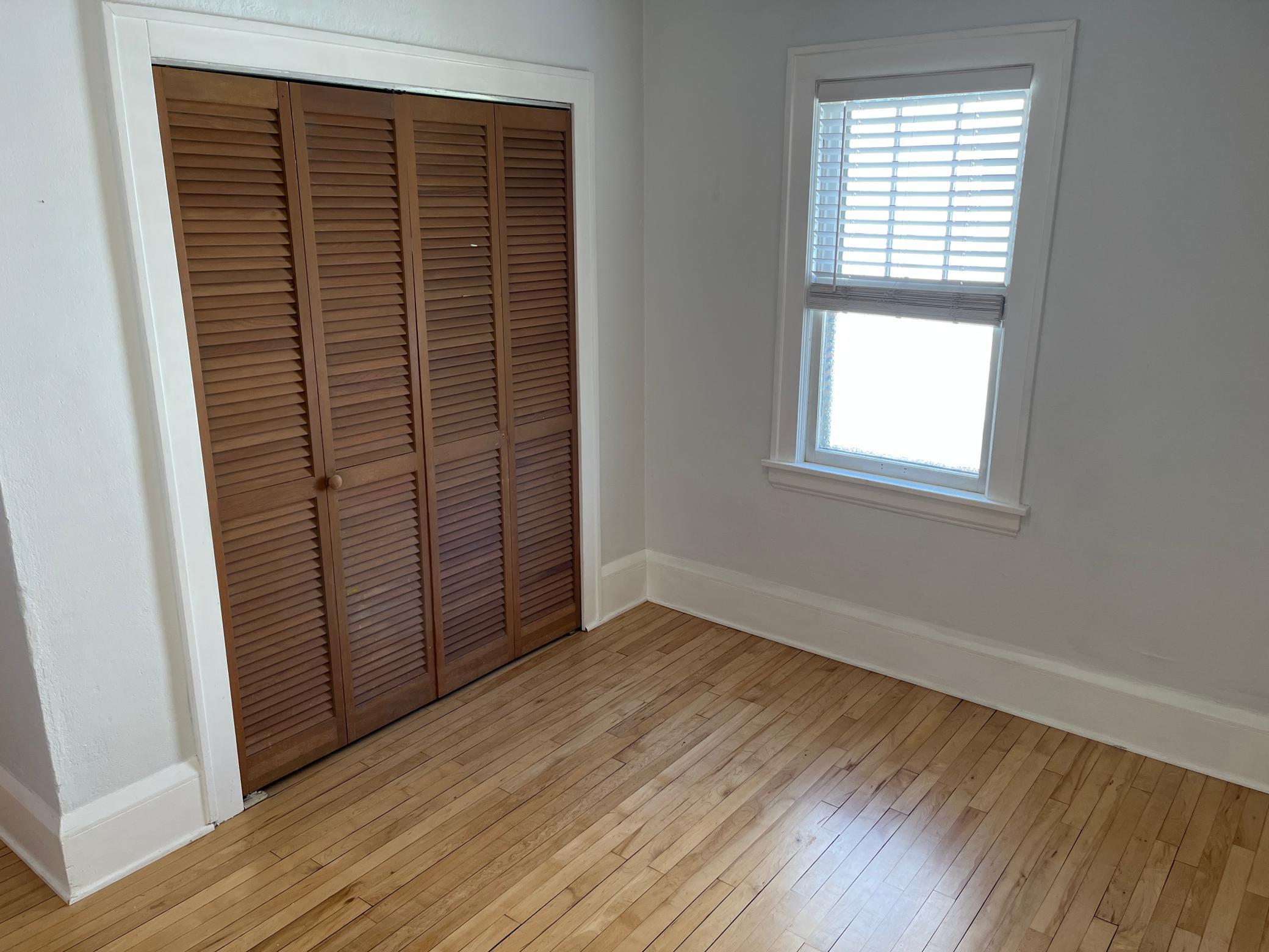 Main Level back bedroom. Maple flooring.