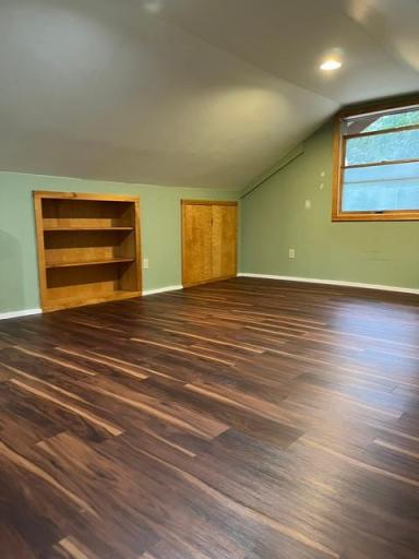 Brand new laminate flooring in the upper level. Built-in bookshelves. Access panel to the under roof area.