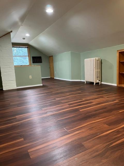 A look back at the "foyer" area at the top of the stairs. Wall air conditioner and under roof access panel visible. At the top of the stairs is a large closet built under the rafters. This very useable closet is not considered finished space.