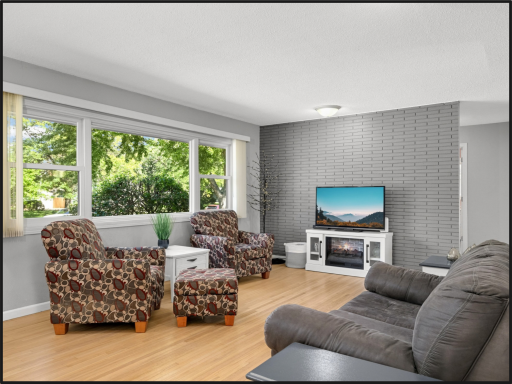 Open living room with hardwood floors and updated windows