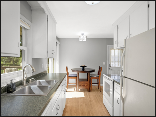 Kitchen with Breakfast nook leading out to deck overlooking backyard