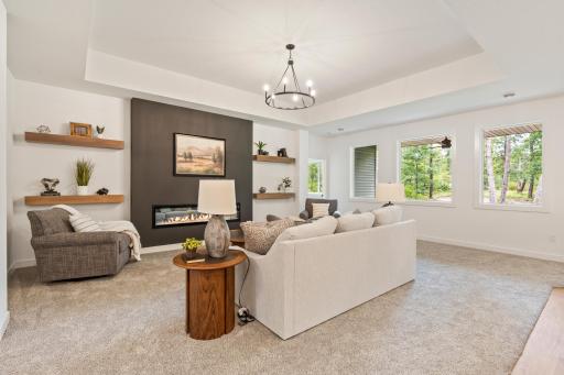 Living room with electric fireplace and floating shelves