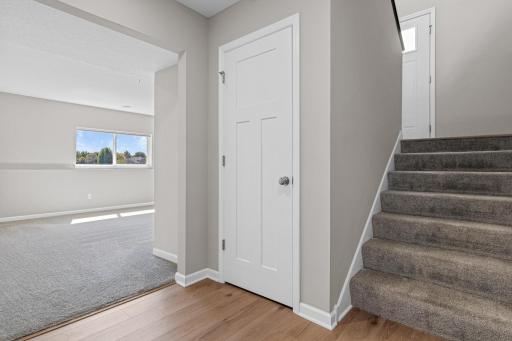 Going to the lower level, there is a large landing at the base of the stairs connecting you to your garage