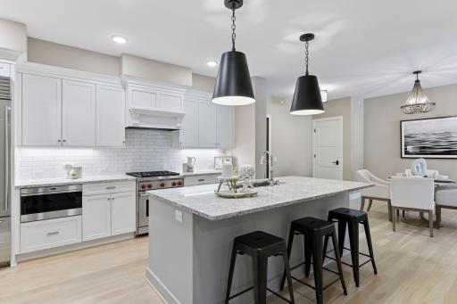Kitchen features Cambria countertops, lots of counter space, and a great spot to meal prep