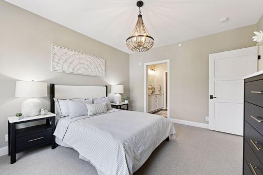 Retreat to the sunlit primary bedroom, complete with an en suite bathroom