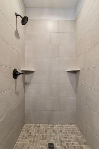 *NOTE: The wood framed mirrors and black shower door have been installed since these photos were taken. New photos coming soon!