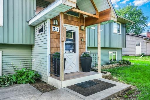 Inviting front entryway with textured wood siding