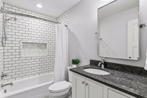 Stylish full bath conveniently located off the upper-level loft and bedroom, featuring a beautifully tiled tub/shower surround, granite vanity, and timeless finishes perfect for family or guests.
