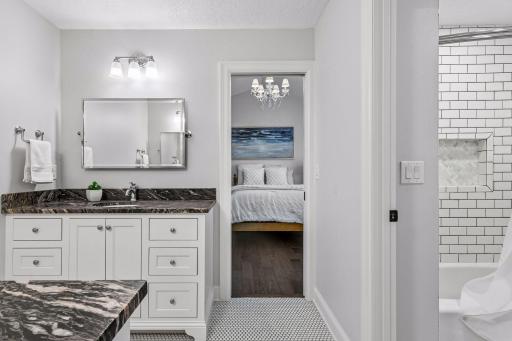 Convenient FULL pass-through bath connects the third and fourth upper-level bedrooms, featuring granite dual vanities, separate tub/shower/stool area all with stylish finishes, and a functional layout that provides comfort, privacy, and convenience.