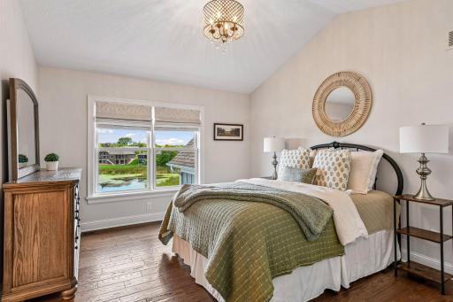 Bright upper-level third bedroom with scenic views of Lake Waconia and pond with direct connection to a full pass-through bathroom, creating a private and welcoming retreat for family or guests.