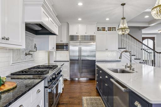 Showstopper chefâs kitchen featuring premium stainless appliances, subzero refrigerator, wolf commercial range w/gas cooktop and dual ovens, designer lighting, walk in pantry and more! Ideal kitchen for entertaining year round.