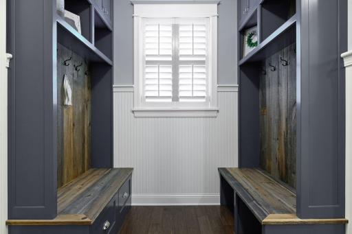 Stay organized with this beautifully crafted mudroom offering custom built-ins, storage cubbies, bench seating, and timeless millwork. Functional design meets exceptional craftsmanship.