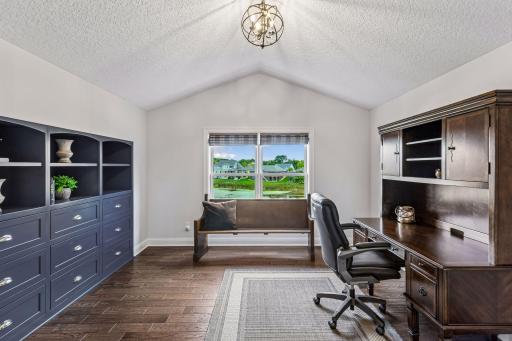 Currently styled as a home office, this versatile upper-level bedroom features custom built-ins, a walk-in closet, and beautiful views. Ideal as a bedroom, office, study, or creative space.